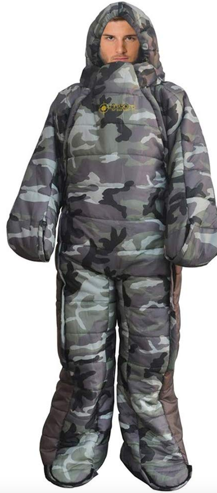 A camouflaged, grey and black  sleeping bag with arms and legs, being worn by a man. 