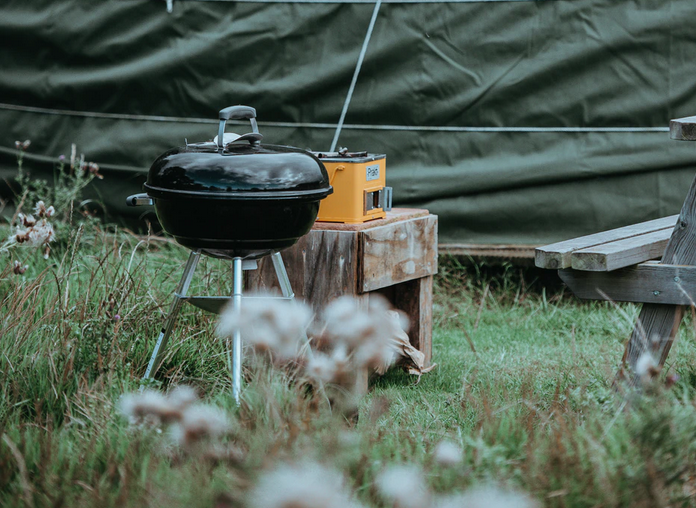 A barbecue outside a tent