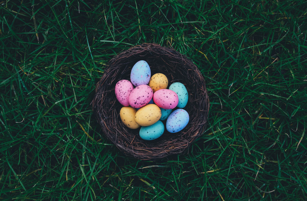 Coloured easter eggs in a brown basket