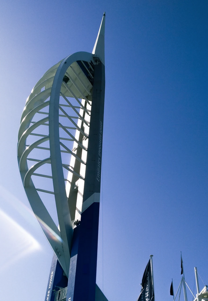 A tall white tower with blue sky