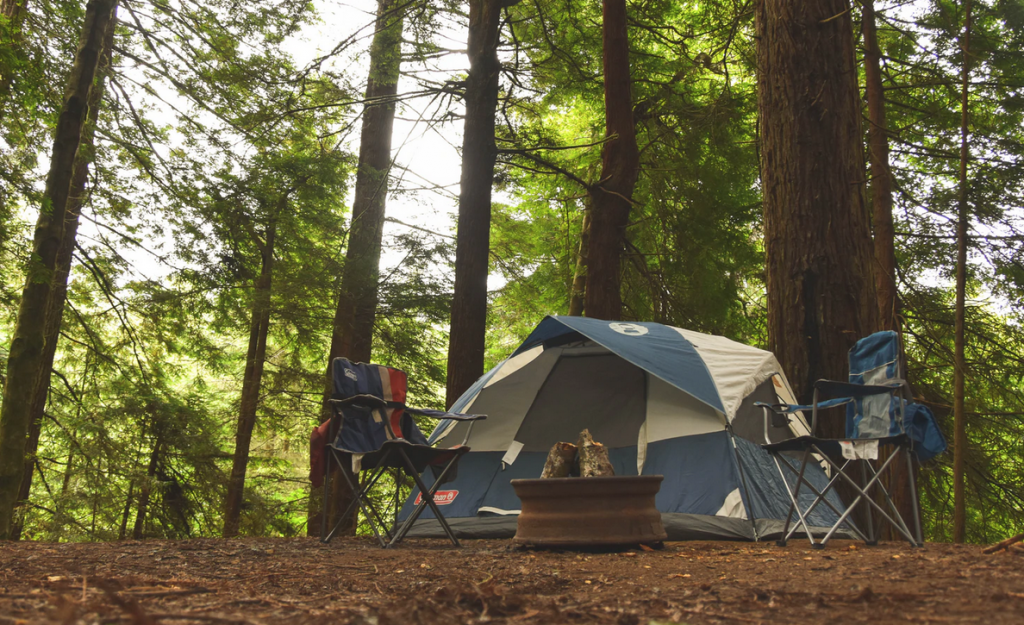 A tent with two camping chairs