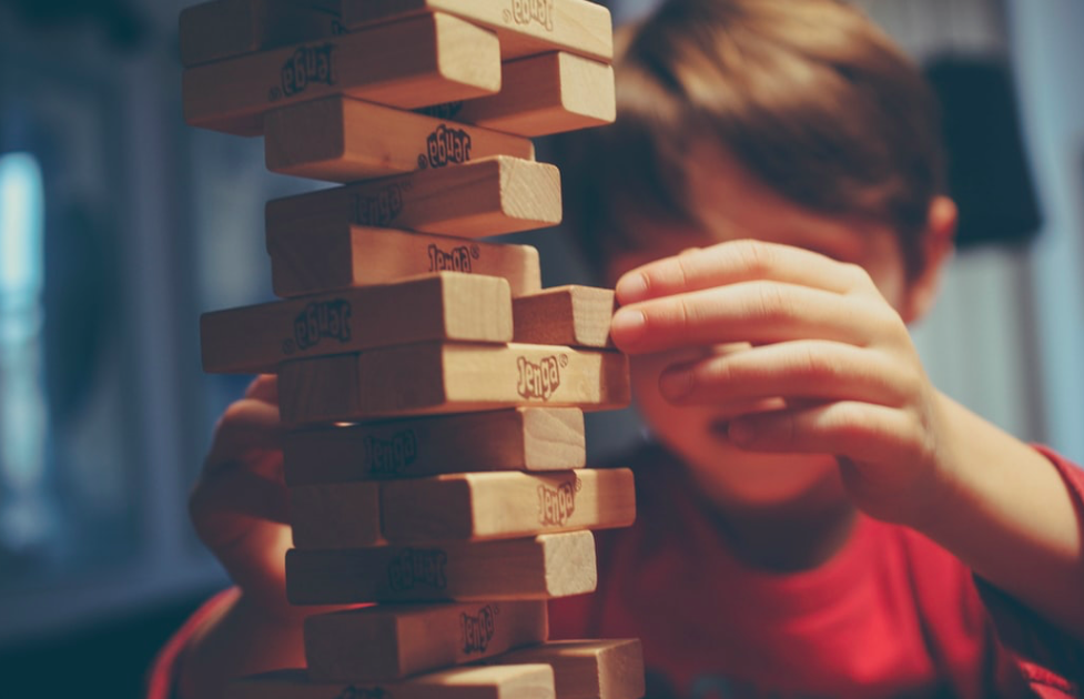 A young boy playing jenga