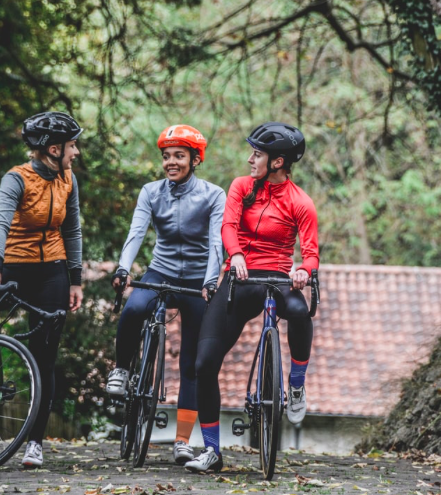 Three women in cycling gear on bikes