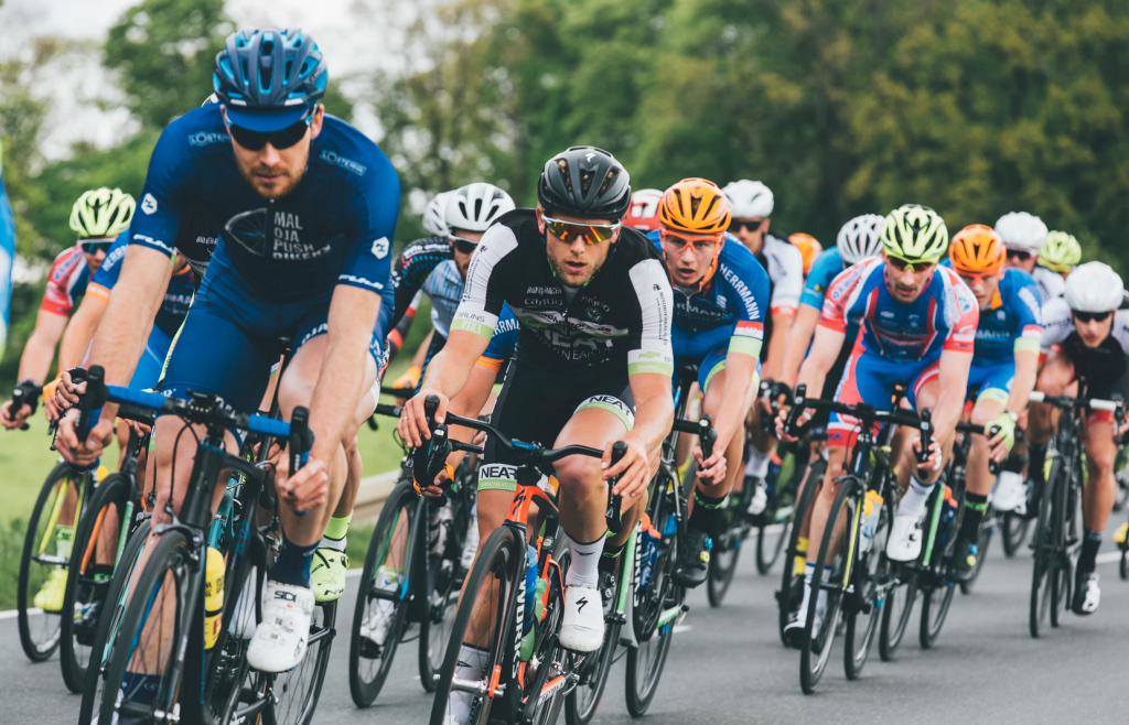 A large group of men cycling on the road