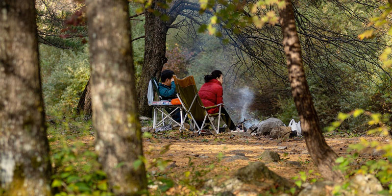 Image of couple around camp fire
